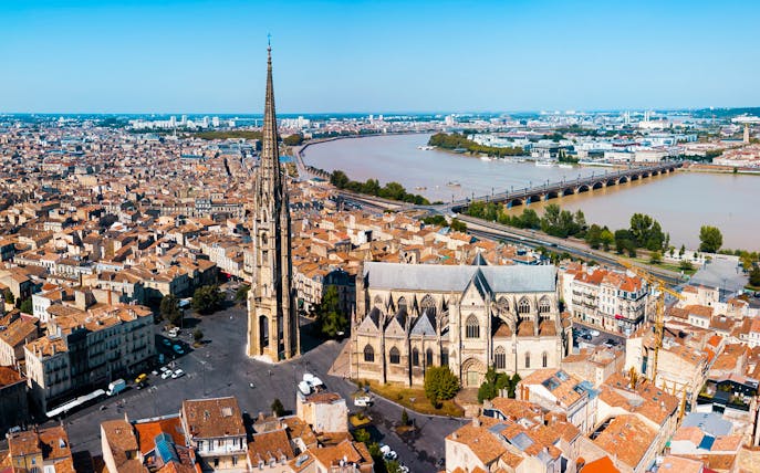 Aerial view of Bordeaux Old Town with Saint-Michel Basilica and Garonne River.