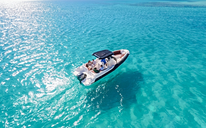 High-speed sea taxi on clear blue waters en route to Orange Bay or Magawish.