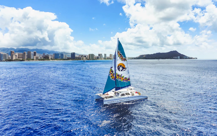 Catamaran sailing near Waikiki with Diamond Head in the background, Hawaii.