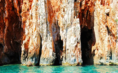 Red rock cliffs with turquoise sea at Hvar Island, Croatia.