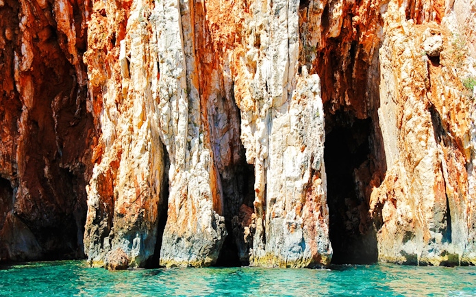 Red rock cliffs with turquoise sea at Hvar Island, Croatia.