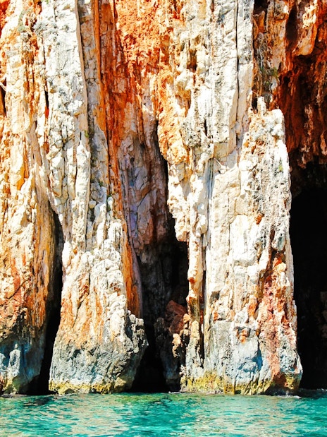 Red rock cliffs with turquoise sea at Hvar Island, Croatia.