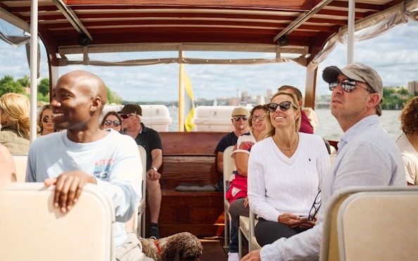 People enjoying a ride on a classic wooden boat in the Stockholm Archipelago.
