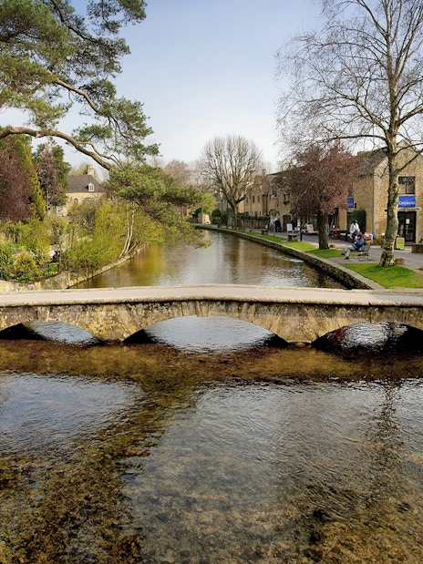 Quaint stone bridge over a river in Bourton-on-the-Water, England.