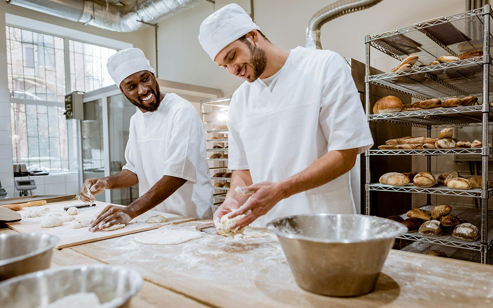 Bakers preparing dough in a bakery during the Bread Festival.