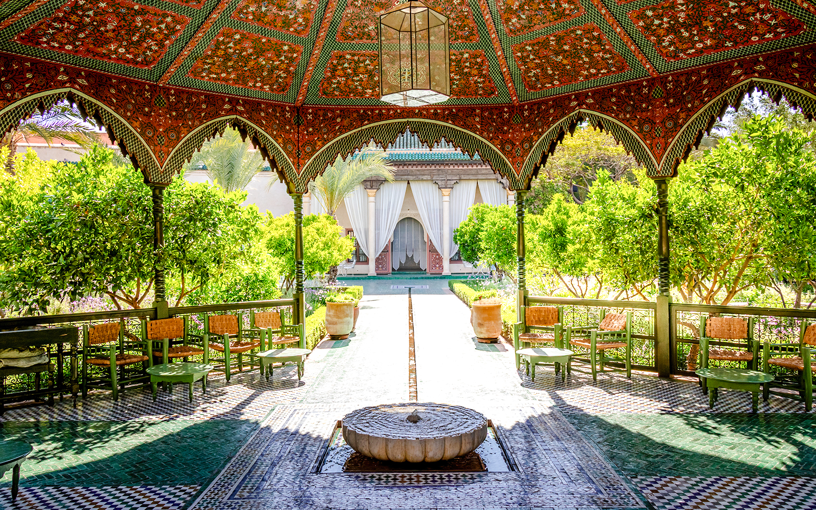 Jardin Secret courtyard with ornate pavilion and lush greenery in Marrakech, Morocco.