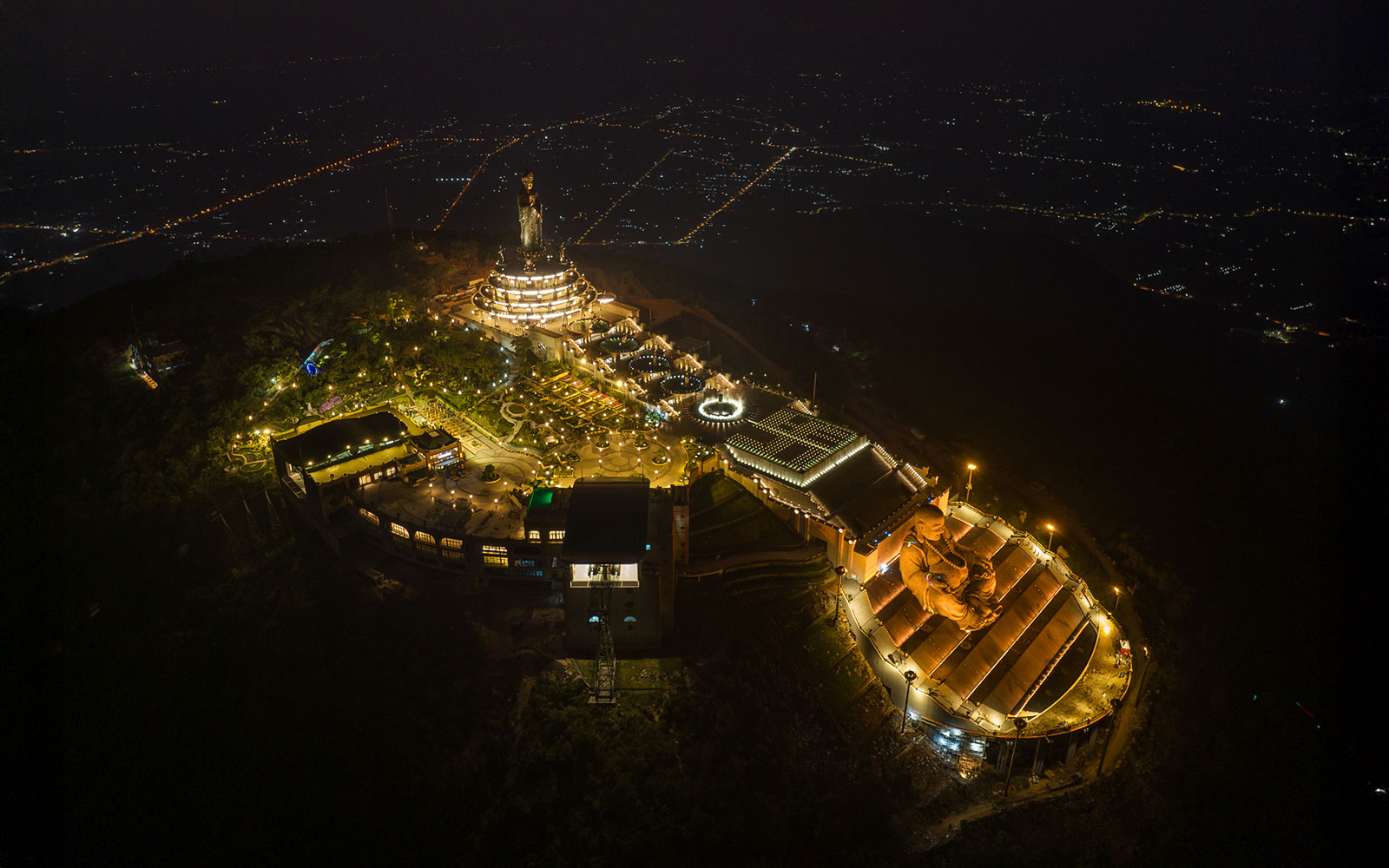 Aerial view of Van Son Peak at night with illuminated Sun World Ba Den Mountain complex.