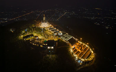 Aerial view of Van Son Peak at night with illuminated Sun World Ba Den Mountain complex.