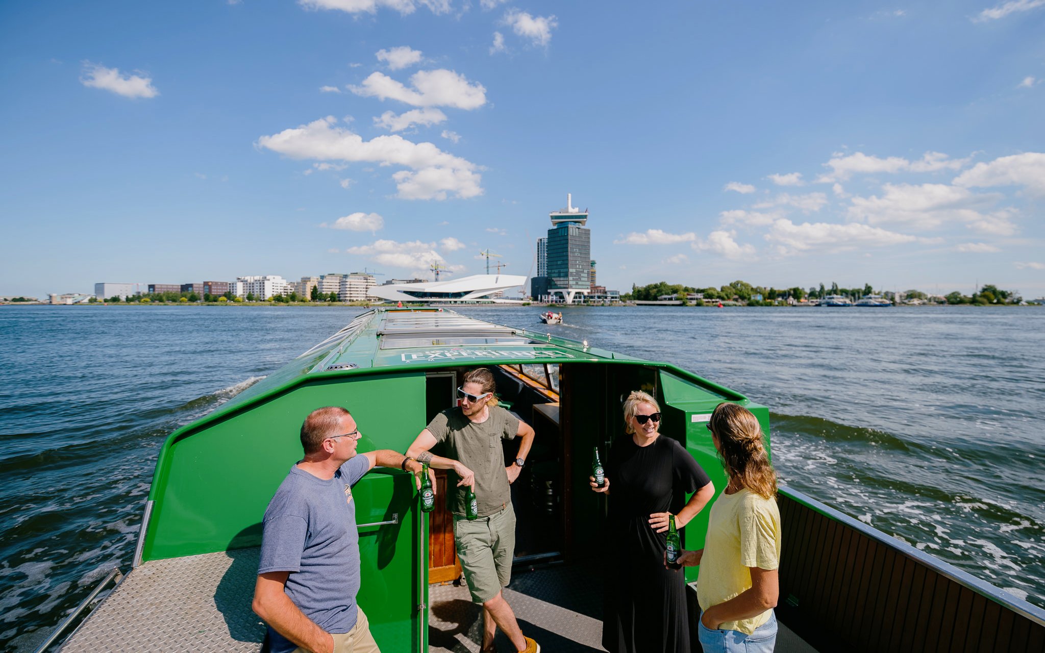 Heineken Canal Cruise with live guide and passengers on a boat in Amsterdam.