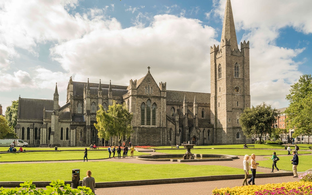 St. Patrick's Cathedral in Dublin with visitors exploring the grounds.