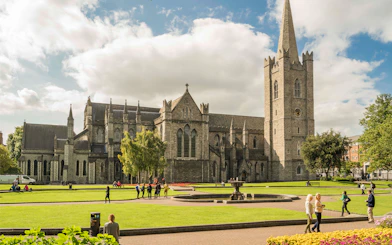St. Patrick's Cathedral in Dublin with visitors exploring the grounds.