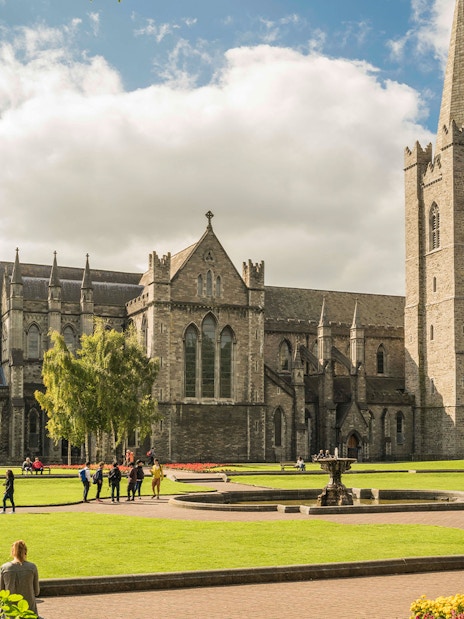 St. Patrick's Cathedral in Dublin with visitors exploring the grounds.