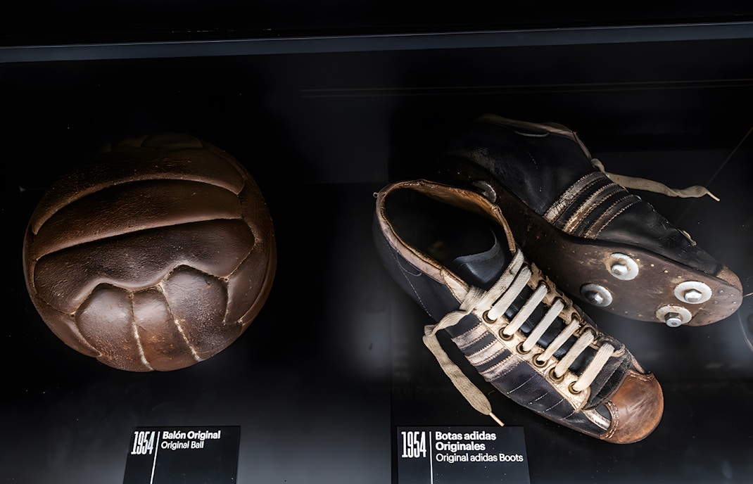 Football artifacts display at Legends Collection in Madrid featuring historic memorabilia.