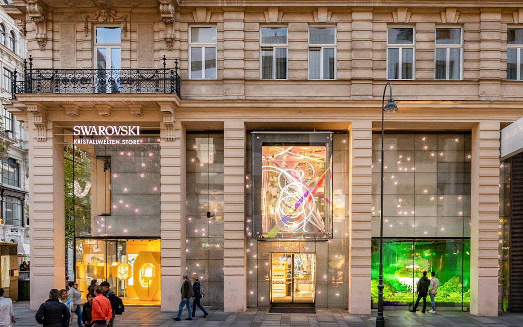 Swarovski Kristallwelten Store facade in Vienna, featuring illuminated displays.