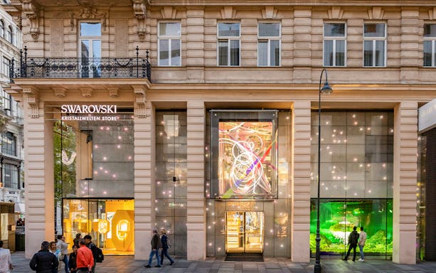 Swarovski Kristallwelten Store facade in Vienna, featuring illuminated displays.