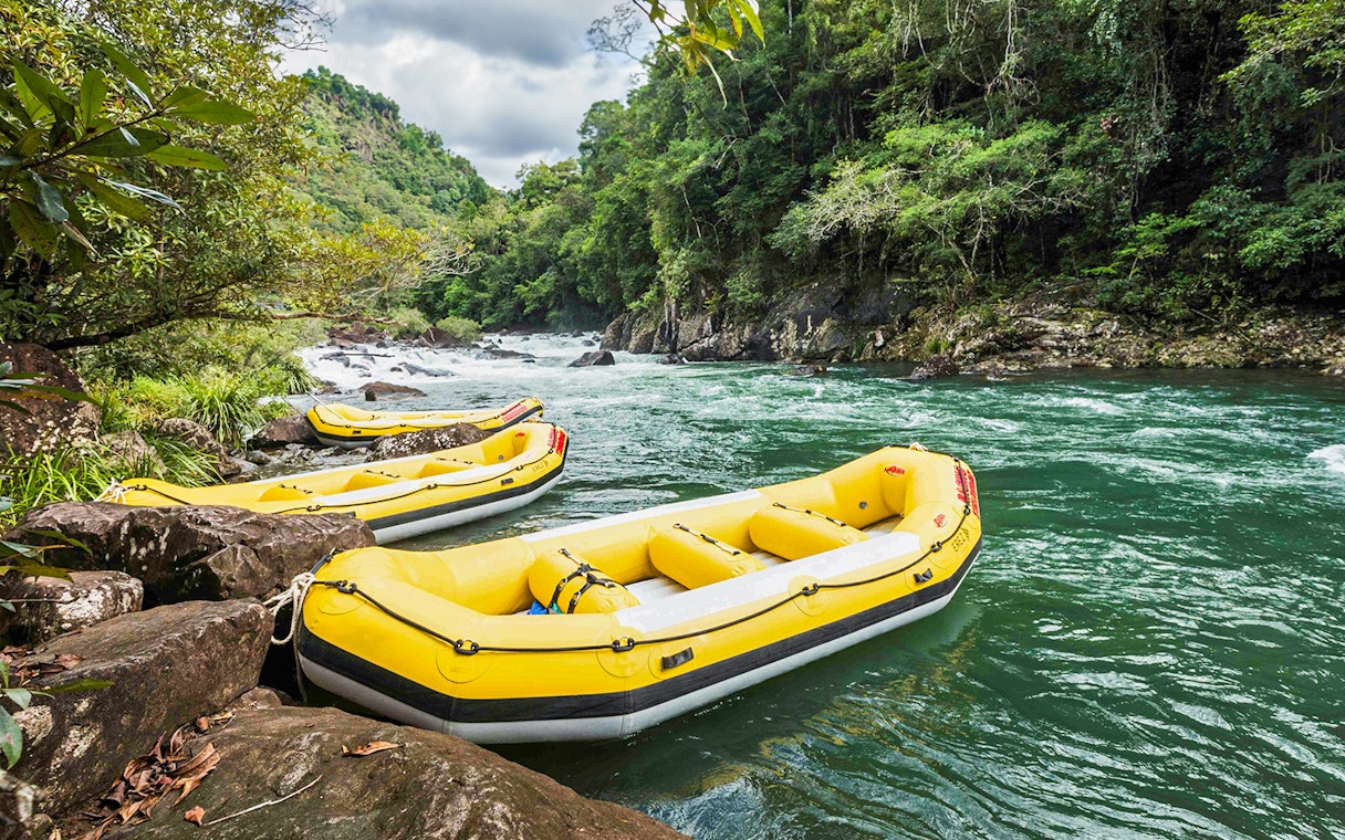 Yellow rafts on Barron River for guided Raging Thunder rafting experience.