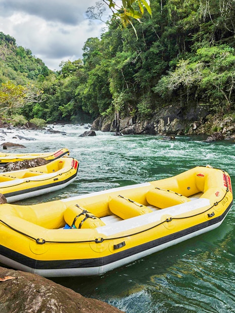 Yellow rafts on Barron River for guided Raging Thunder rafting experience.