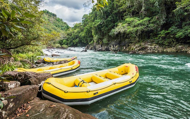 Yellow rafts on Barron River for guided Raging Thunder rafting experience.