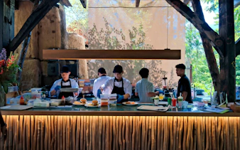 Chefs preparing brunch at Bali Zoo with drinks and dishes on the counter.