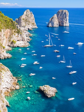 Boats sailing near the Faraglioni rock formations on the Sorrento to Amalfi coast.