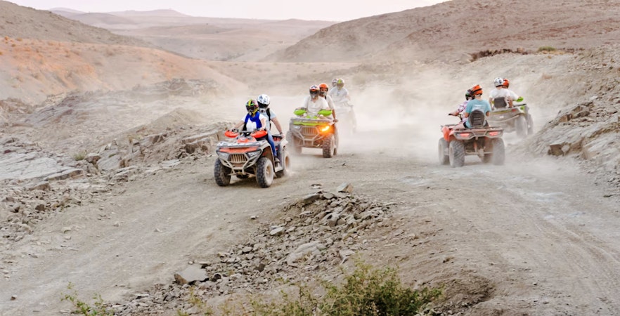 People riding ATVs in Agafay Desert, Marrakesh.