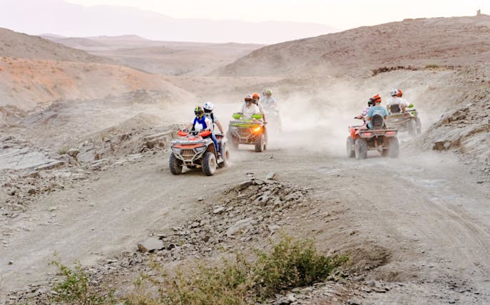 People riding ATVs in Agafay Desert, Marrakesh.