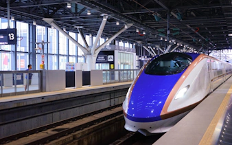 Hokuriku Shinkansen Hakutaka bullet train at a station platform in Japan.