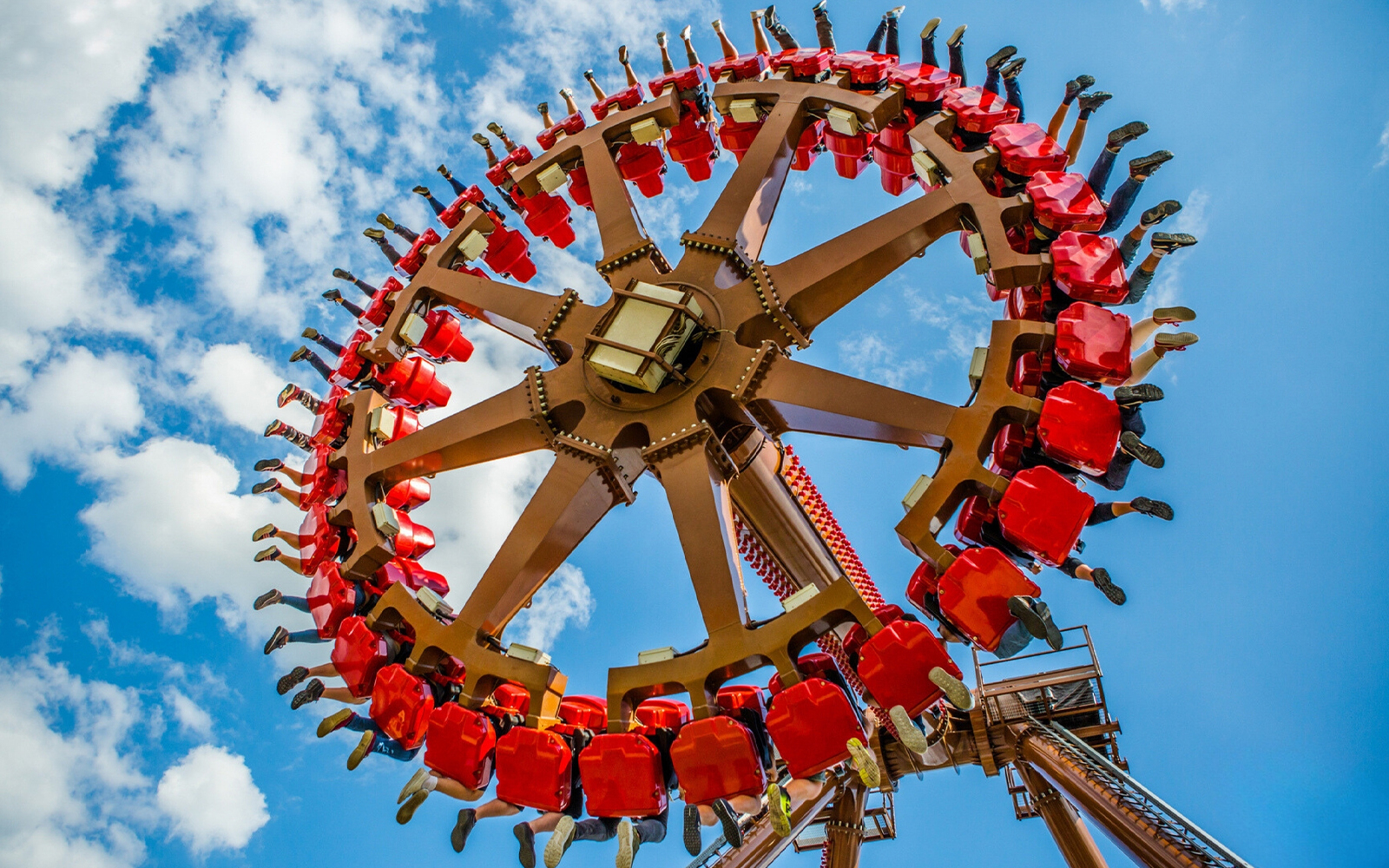 Aztec Swing ride at Energylandia amusement park, Poland, with riders in motion.