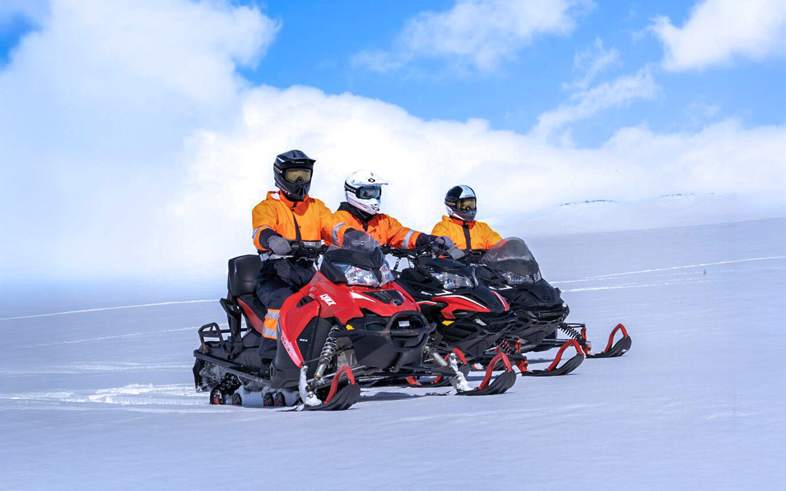 Snowmobile riders on Langjökull Glacier in Iceland.