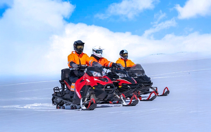 Snowmobile riders on Langjökull Glacier in Iceland.