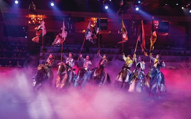 Knights on horseback with flags at Tournament of Kings show in Las Vegas.