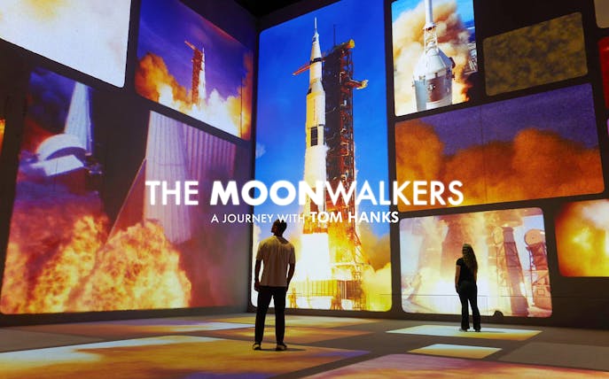 Interactive space exhibit with rocket launch visuals, part of The Moonwalkers tour.