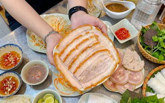 Sliced pork belly with Vietnamese herbs and sauces on Da Nang food tour.