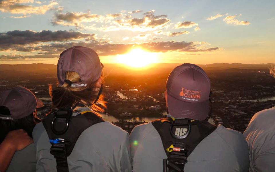 Guests enjoying sunset views from SkyPoint Climb at twilight, Gold Coast.