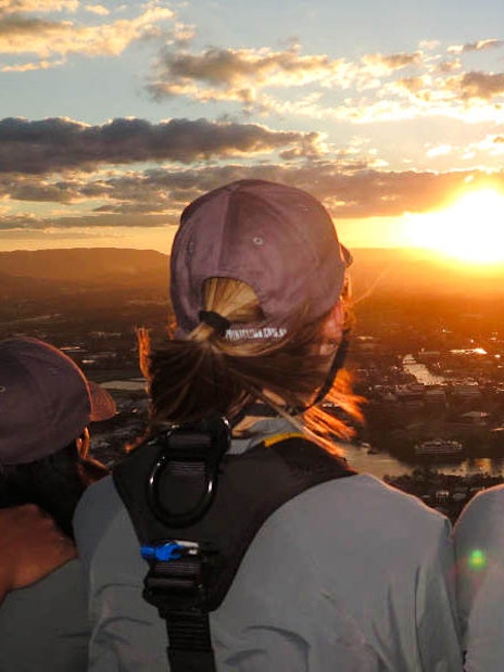 Guests enjoying sunset views from SkyPoint Climb at twilight, Gold Coast.