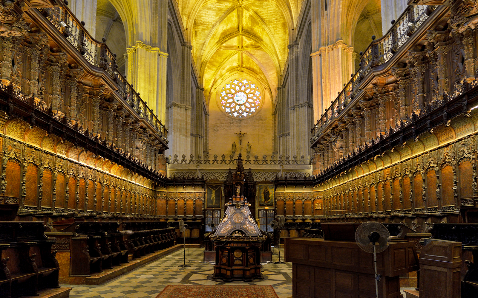 Chapel interior with ornate wooden choir stalls in Cathedral of Sevilla, Spain.