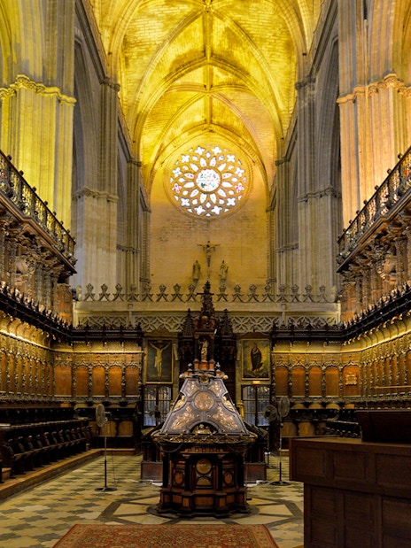 Chapel interior with ornate wooden choir stalls in Cathedral of Sevilla, Spain.