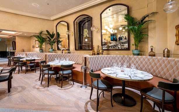 Breakfast setting at Brasserie Rosalie in Paris with croissants and coffee on a table.