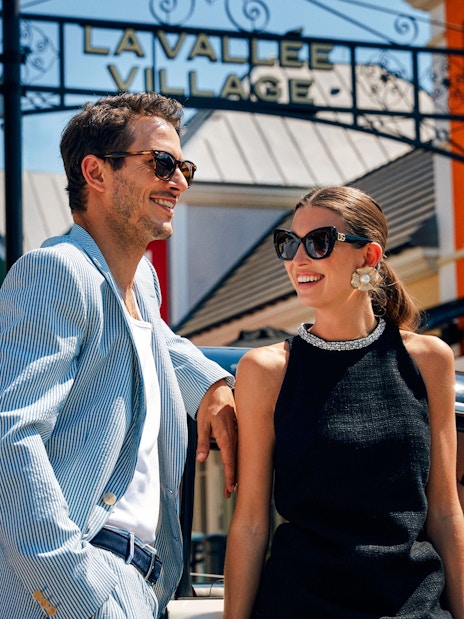 Couple enjoying a day at La Vallée Village, Paris, France.