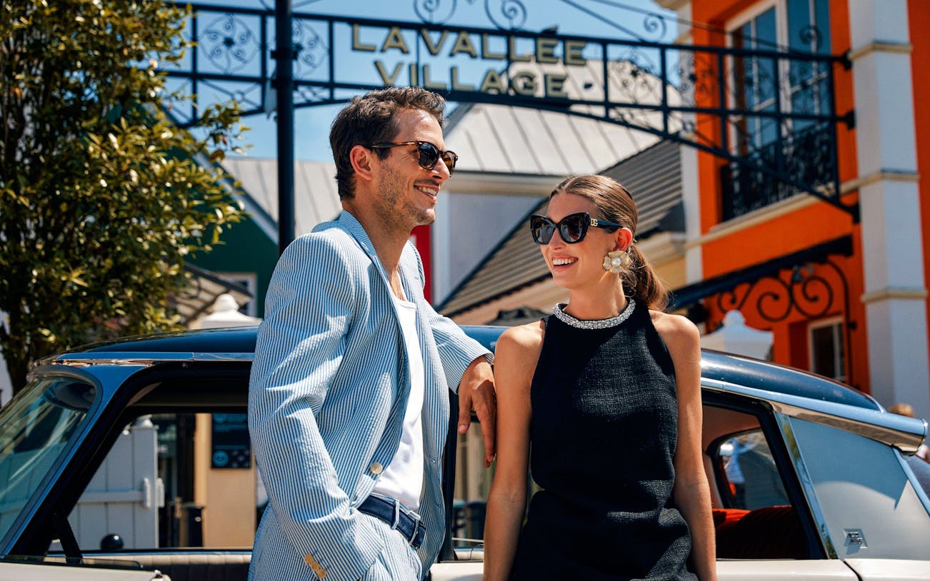 Couple enjoying a day at La Vallée Village, Paris, France.