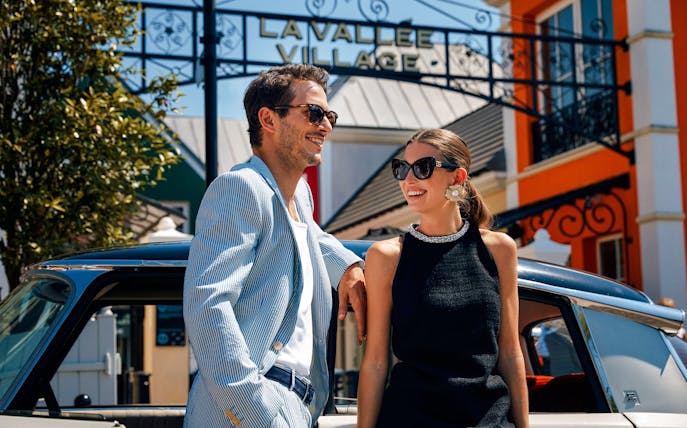 Couple enjoying a day at La Vallée Village, Paris, France.
