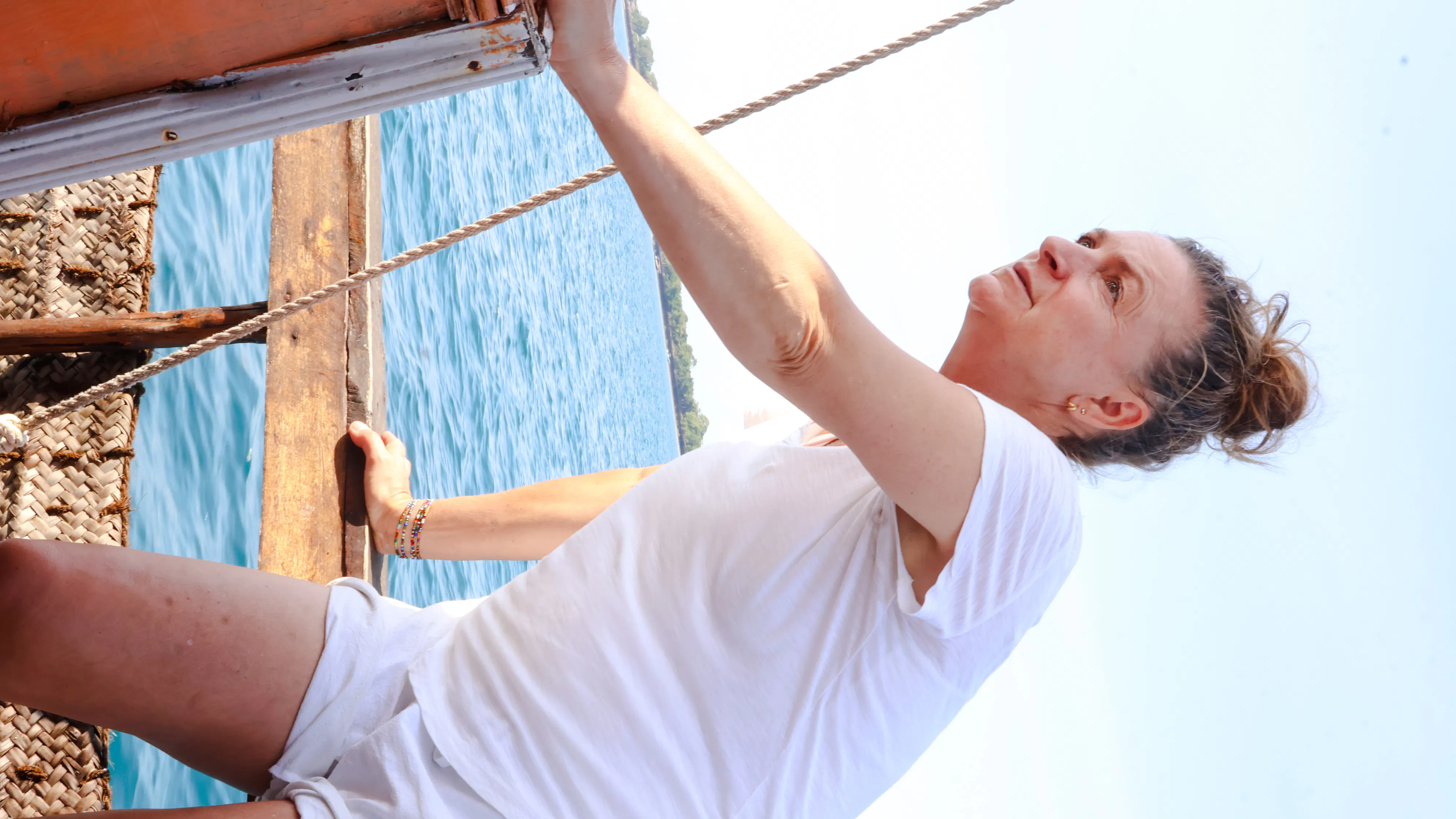 Person sailing on a traditional dhow near Wasini Island, Kenya.
