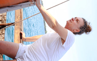 Person sailing on a traditional dhow near Wasini Island, Kenya.
