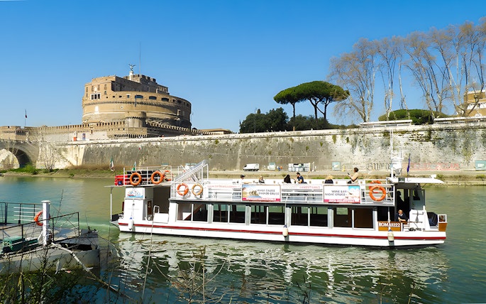 River cruise boat on the Tiber River near Castel Sant'Angelo, Rome.