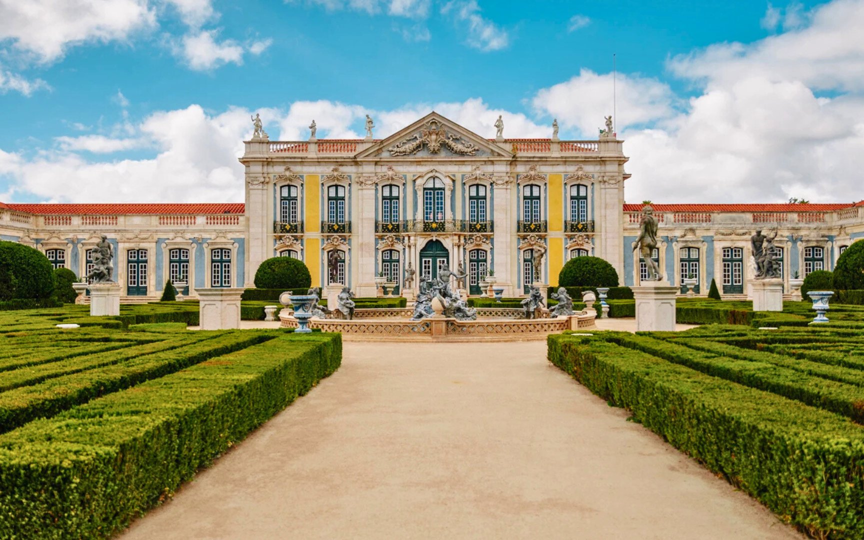 National Palace of Queluz with manicured gardens and statues in Sintra, Portugal.