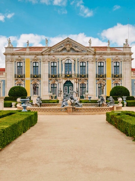 National Palace of Queluz with manicured gardens and statues in Sintra, Portugal.