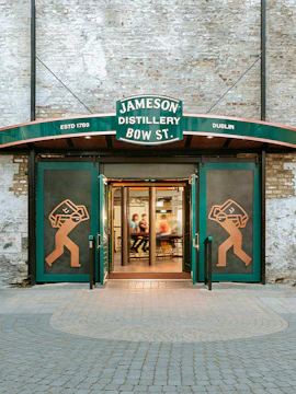 Entrance to Jameson Distillery Bow St. in Dublin, showcasing iconic signage and open doors.