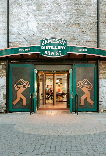Entrance to Jameson Distillery Bow St. in Dublin, showcasing iconic signage and open doors.