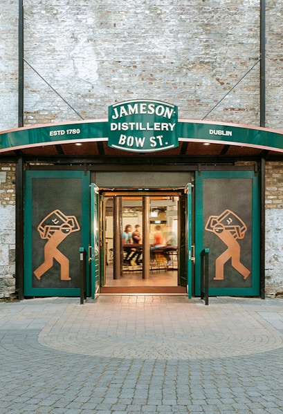 Entrance to Jameson Distillery Bow St. in Dublin, showcasing iconic signage and open doors.