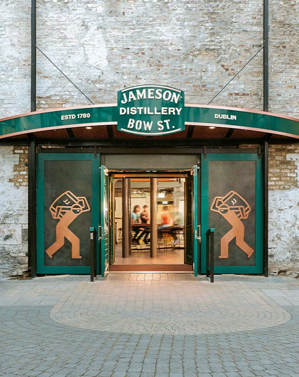 Entrance to Jameson Distillery Bow St. in Dublin, showcasing iconic signage and open doors.